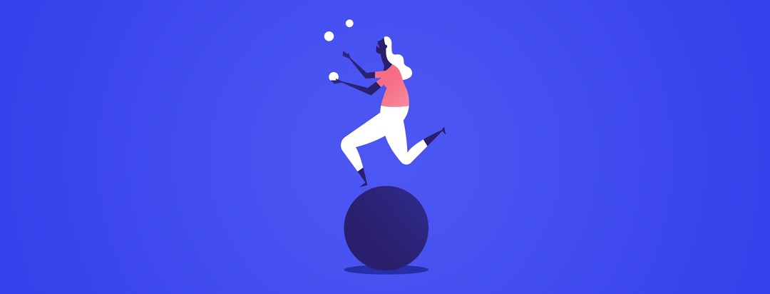 women balancing on a large ball juggling