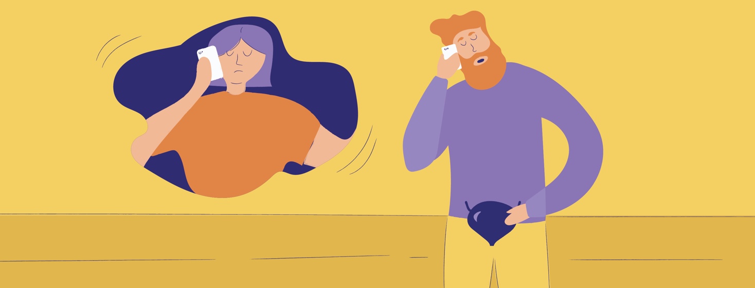 man touching his bladder while on the phone with his wife