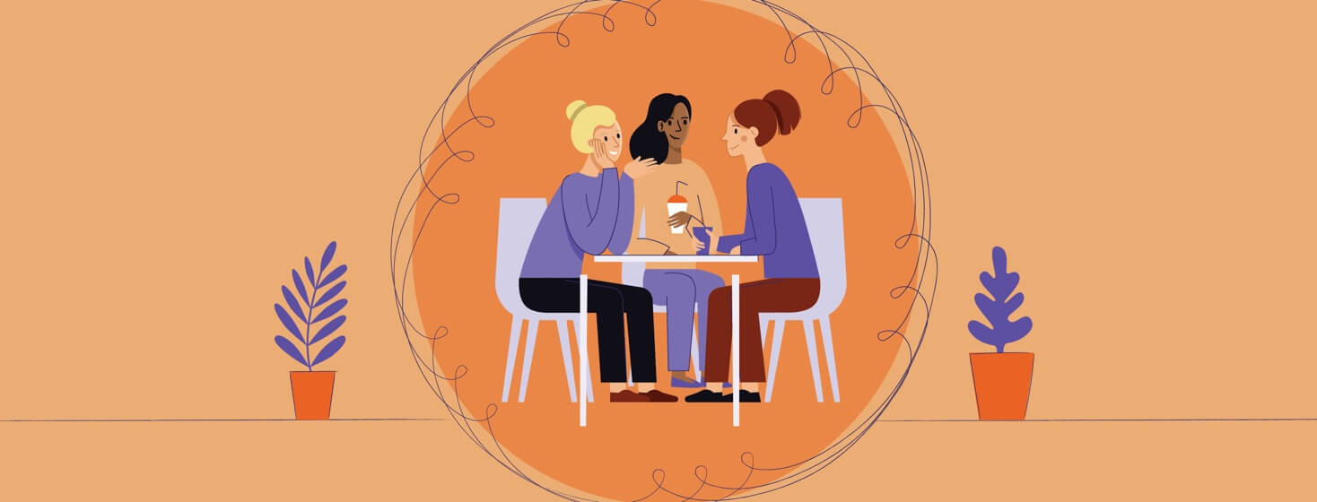 Three women sitting at a table talking