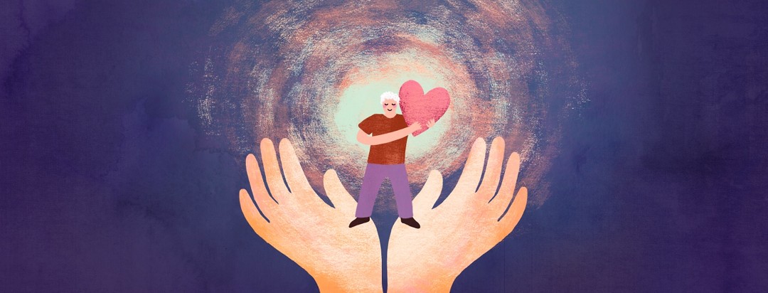 A man stands on two outstretched hands, holding a glowing heart.