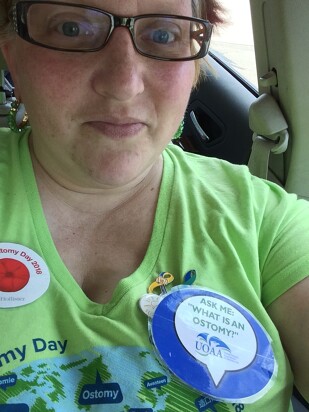 selfie Of advocate in green shirt with Ostomy buttons on it